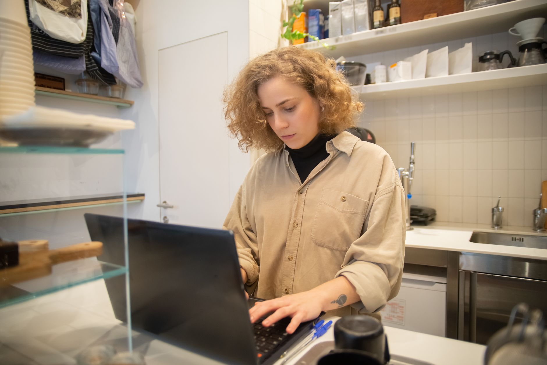 A small business owner pricing a website on a laptop
